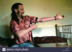 Heroin addict in his bedroom preparing to inject.